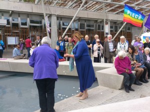 Scottish Minister Fiona Hislop casts petals in the pond